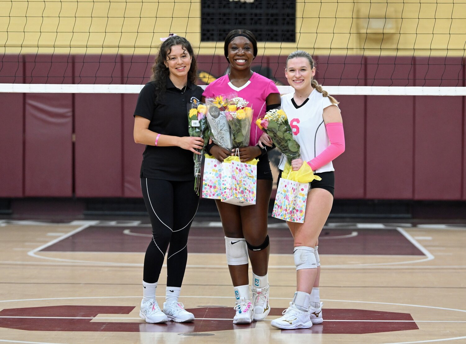 Pictured from left to right:  JoJo Ibarra (Assistant Coach), Dakari Grant, and Jessica Fluharty (Captain),
