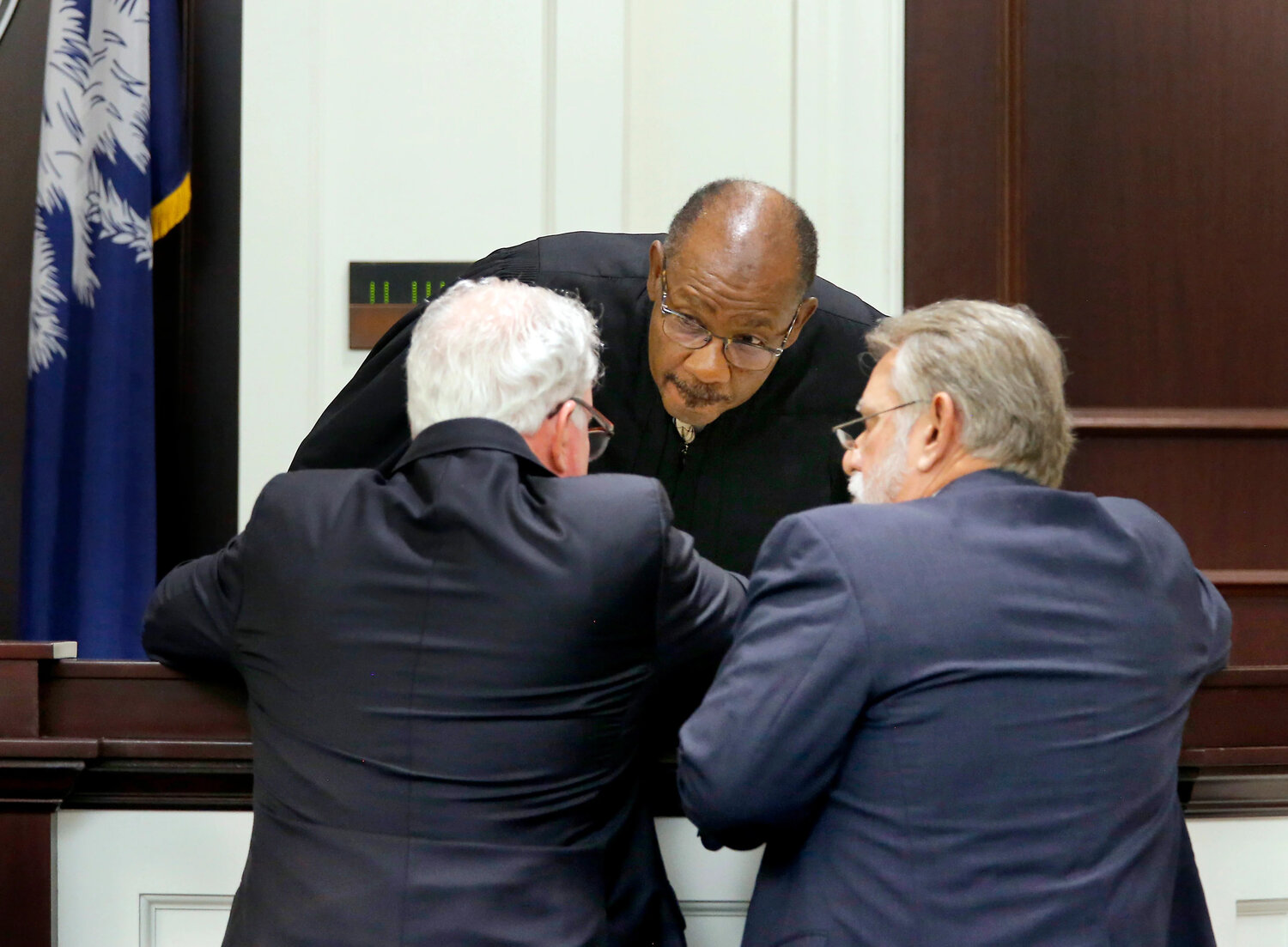 Defense attorney Andy Savage and Deputy Solicitor Bruce DuRant confer with Circuit Judge Clifton Newman during Michael Slager’s murder trial at the Charleston County courthouse. File/Grace Beahm/Staff