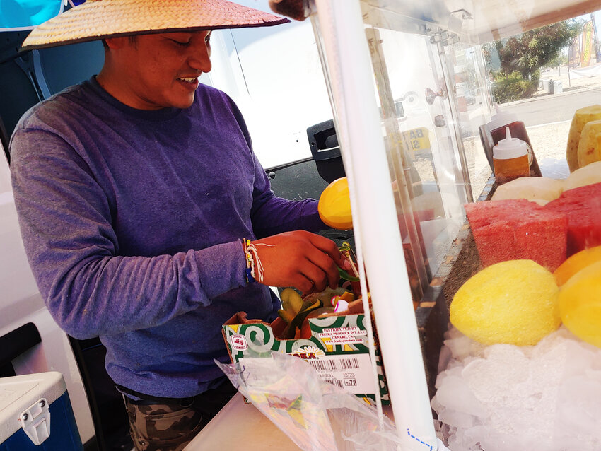 Juan Tepetzi this past Friday was at his usual roadside spot at 43rd and Peoria avenues in Glendale slicing up mangos for his 32-ounce fresh fruit cups with plenty of ice.