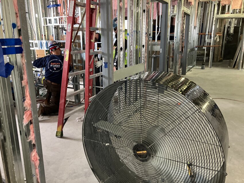 Large fans circulate air to keep construction workers cool at Abrazo Arrowhead Campus.