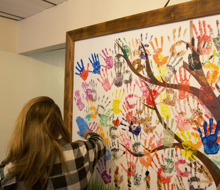 Human trafficking survivors who have branding marks removed put handprints on the Freedom Wall to signify freedom and new beginnings. (Photo by Hunter Fore/Cronkite News)