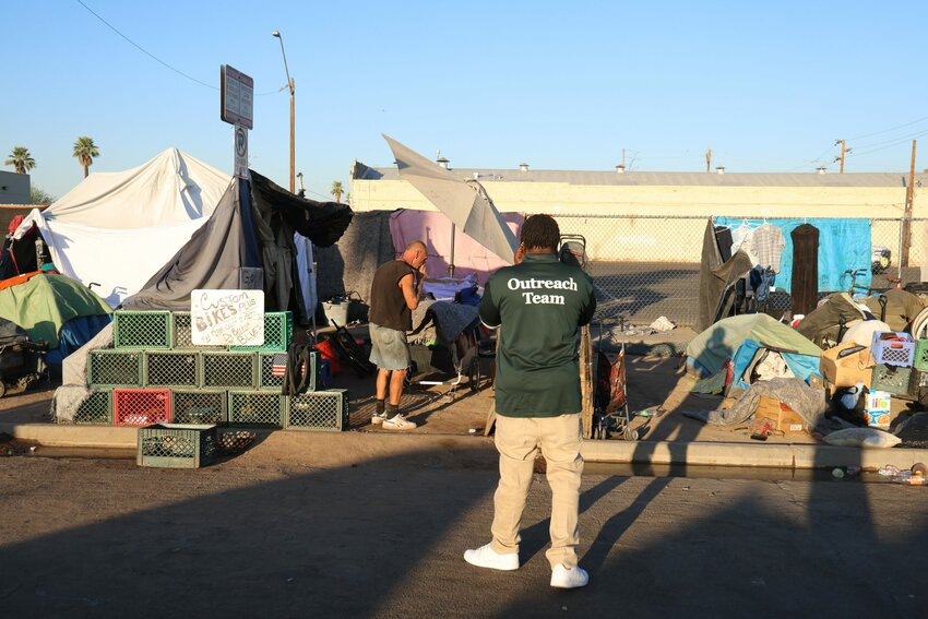 Teams from outreach organizations coordinate with the city on Oct. 20 to facilitate the removal of tents and property owned by people who have lived in The Zone, once one of the largest homeless encampments in the country. (Photo by John Leos/Cronkite News)