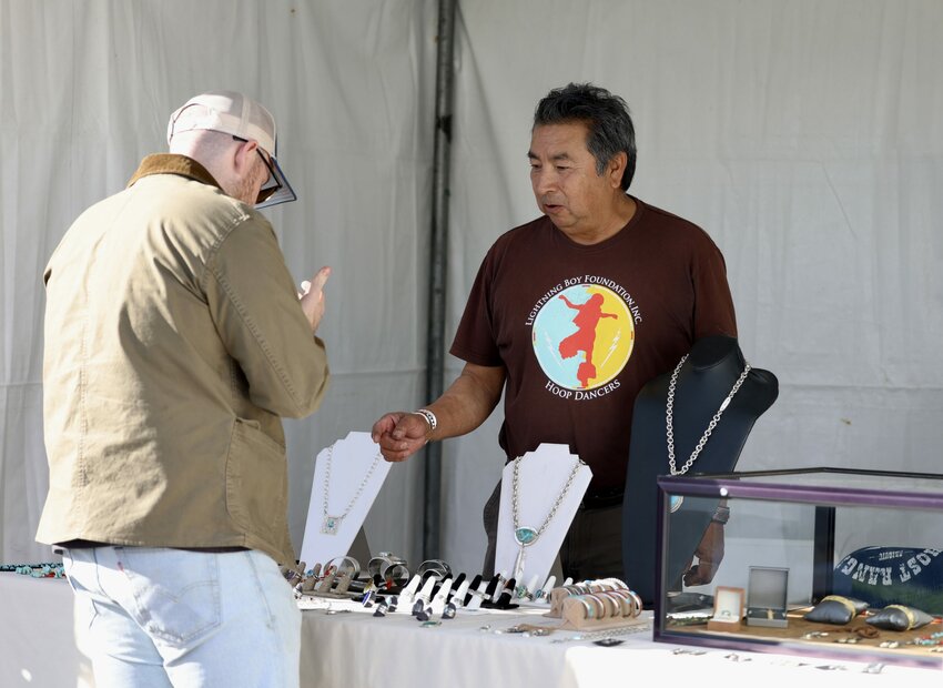 Steve LaRance, right, talks to Arizona Indian Festival visitor Graham Chapman on Feb. 3, 2024. (Photo by Marnie Jordan/Cronkite News)