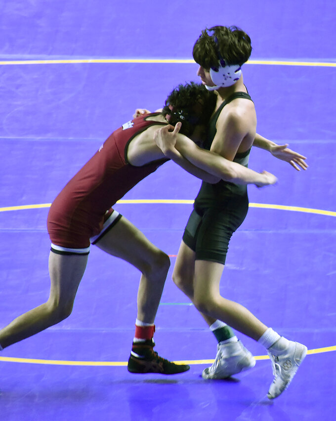 Chris Ramirez of Canyon Vista, right, wrestles Daniel Alire of Kofa in the Division II boys 106-pound final at this weekend’s state championships at Veterans Coliseum. Ramirez, one of four Jaguars to win individual state titles Saturday, helped lead Canyon View to its first state team championship. 