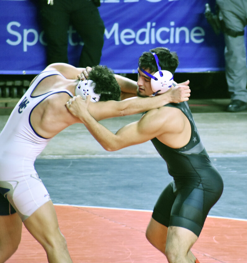 Asher Villapando of Canyon Vista, right, wrestles Gadiel Meraz of Willow Canyon in a Division II boys 175-pound match Saturday at the state championships at Veterans Coliseum. Villapando, one of four Jaguars to win individual state titles Saturday, helped lead Canyon View to its first state team championship.