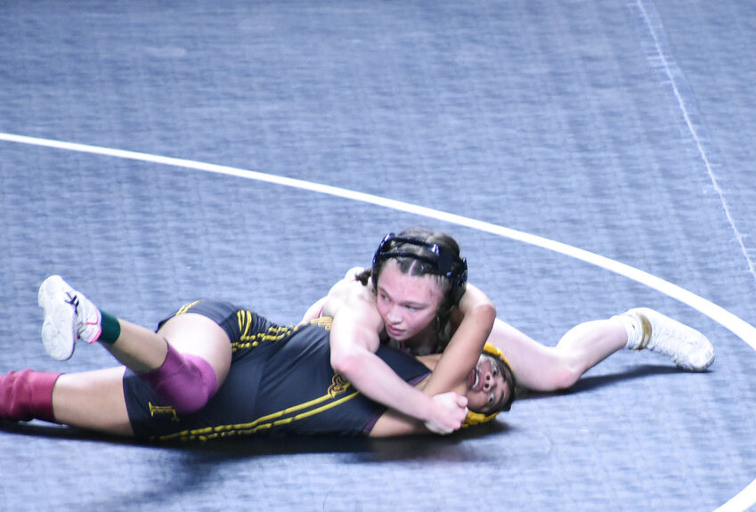 Perry’s Addison Palmer is about to pin Makayla Lopez of Tolleson High in the third-place 100-pound match Feb. 17 at Veterans Coliseum.