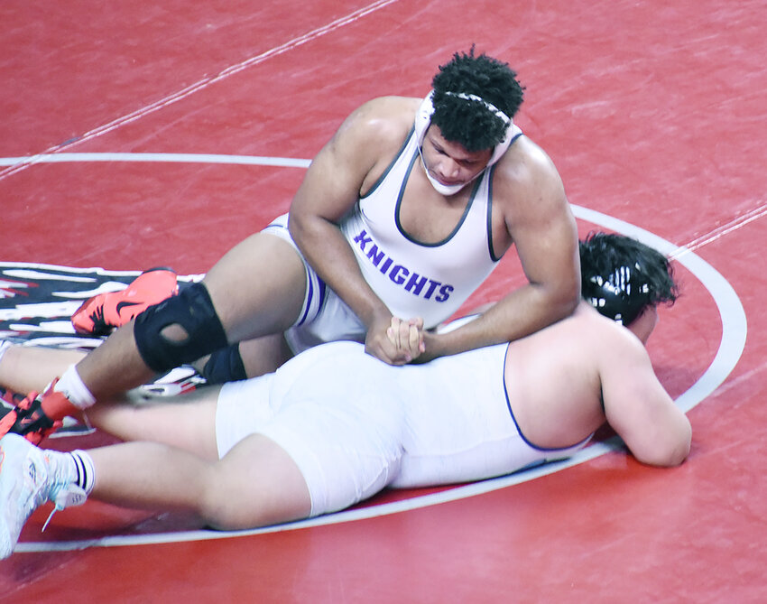 Arizona College Prep’s Nick Hutchins keeps Deer Valley’s Santiago Reyes’ arm behind his back during their  285-pound Division III state title Feb. 17 at Veterans Coliseum. Hutchins won the match, 2-1, to claim the title. 