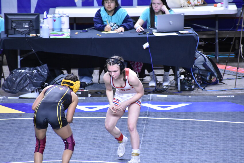 Perry’s Addison Palmer, facing the camera, squares up with Makayla Lopez of Tolleson High in the girls Division II 100-pound third-place match Feb. 17 at Veterans Coliseum. 