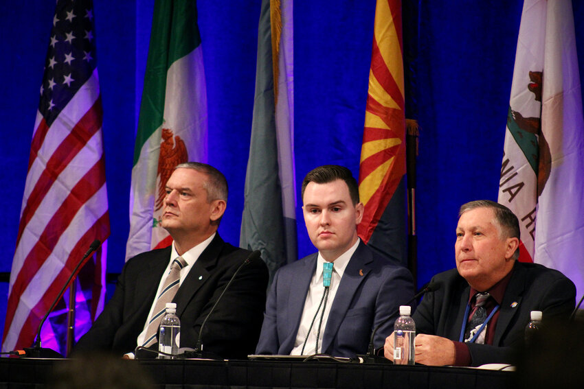 From left, John Entsminger, JB Hamby and Tom Buschatzke, the top water negotiators for Nevada, California and Arizona, respectively, sit on a panel at the Colorado River Water Users Association annual meeting in Las Vegas on Dec. 14, 2023. (Photo by Alex Hager/KUNC)
