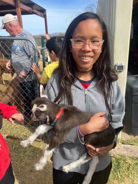 Seventh grader Mackenzie Heckart holds a baby goat. (Courtesy San Tan Charter School)