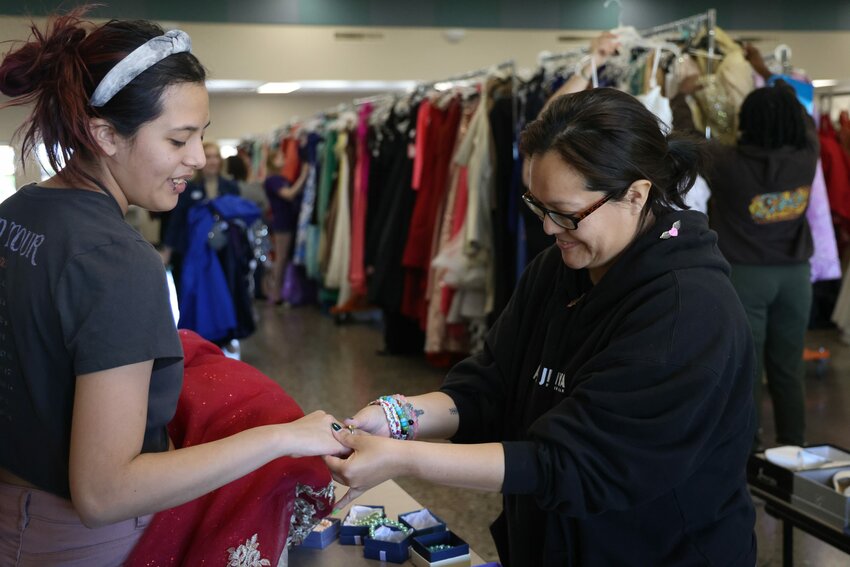 Dacia Wagoner, right, puts a ring on her daughter, Zoe Jane Sandige, as they look at the jewelry options at The Prom Closet in Glendale on April 6, 2024. (Photo by Lauren Kobley/Cronkite News)