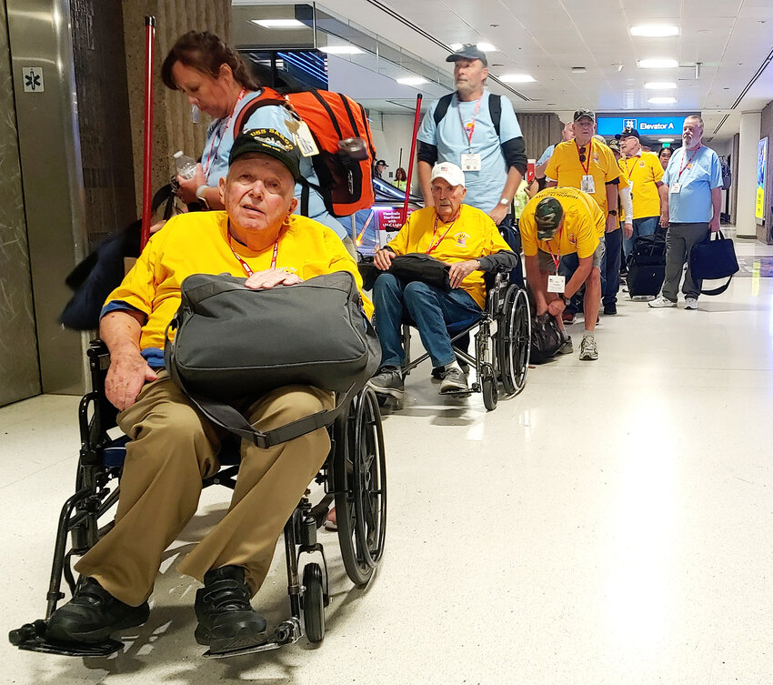 A group of some 25 armed forces veterans make their way to the gate at Sky Harbor International Airport in Phoenix on April 10.