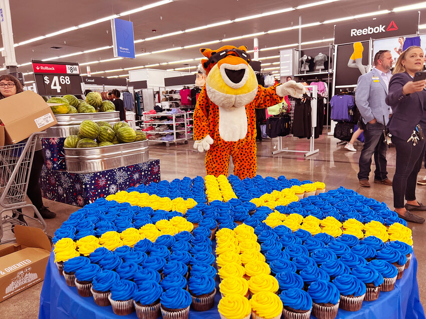 Chester Cheetah eyes a large display of Walmart-colored cupcakes at a May 17 ribbon cutting for a remodel of the Supercenter at Warner and Alma School roads in Chandler.