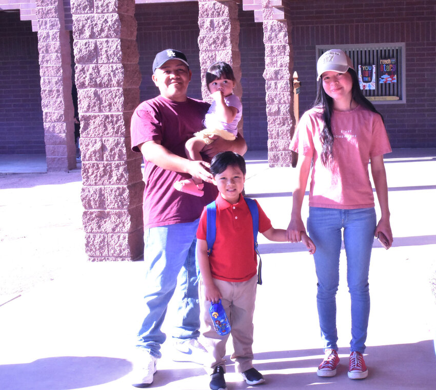 Kindergartner Mateo Ernesto poses with his family at Shumway Leadership Academy on July 17, the first day of the Chandler Unified School District school year. 