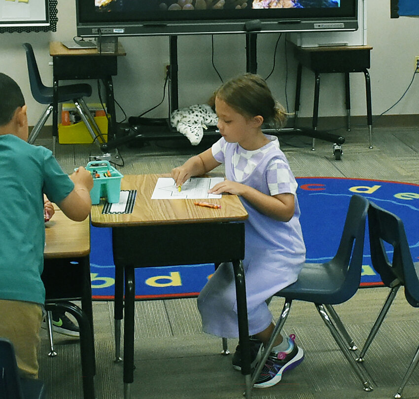 Kindergartner Alina Reyes takes an on early coloring exercise in her Bologna Elementary School classroom on July 17, the first day of the Chandler Unified School District school year. 