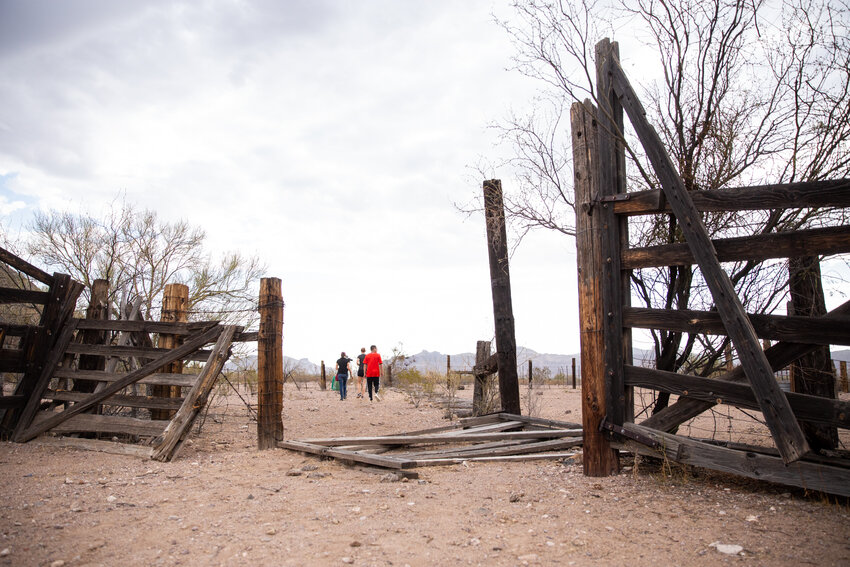 Volunteers for No More Deaths walk through an abandoned corral, one of many sites where the organization leaves food and water for migrants crossing the desert in southern Arizona. (File photo by Ellen O’Brien/Cronkite News)