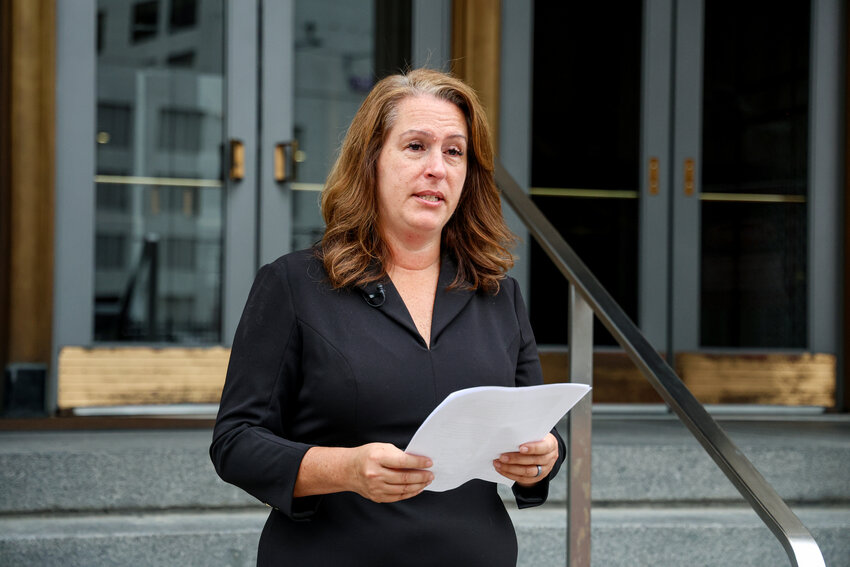 Tina Barton, a former elections official who now serves as vice chair of the Committee for Safe and Secure Elections, reads her victim impact statement outside the federal courthouse in Detroit on Tuesday, July 9, 2024. Just after the 2020 election, an Indiana man left Barton a voicemail threatening to “take you out.” He was sentenced to 14 months in prison. (Photo by Olivia Talkington/News21)