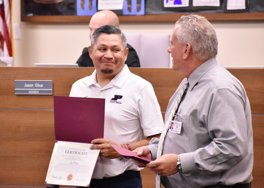 Perry High School football coach Joesph Ortiz smiles at Chandler Unified School District Superintendent Frank Narducci during a Hispanic Heritage Month event. 