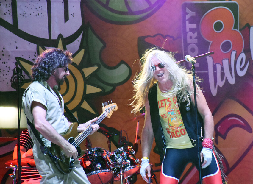 The "Michael Anthony" band member, left, and the "David Lee Roth" of theVan Halen cover band Bottoms Up jam along as they headline the stage entertainment at the 12th annual Rockin’ Taco Fest Sept. 14 at A.J. Chandler Park.