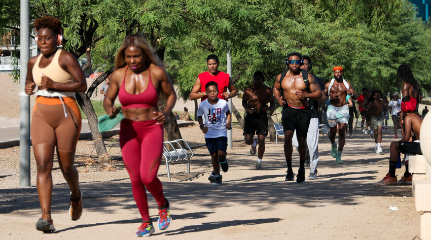 Every Sunday at 7:30 a.m., people join the BLK Arizona Run Club at Tempe Town Lake seeking fitness and community. (Photo by Natalie Lopez/Cronkite News)