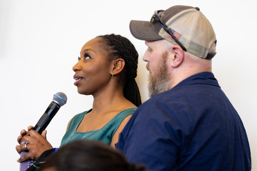 Phoenix residents Quianna Brown, left, and Joe Wiskur speak to Arizona Democratic Sens. Mark Kelly and Ruben Gallego about how Republican-proposed Medicaid cuts will negatively impact their children’s health care at a town hall at the Neighborhood Outreach Access to Health Cholla Health Center on Monday, March 17, 2025, in Scottsdale. (Photo by Alexis Heichman/Cronkite News)