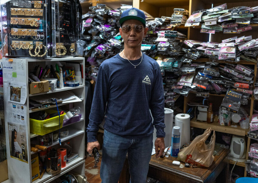 Daniel Son, whose family owns United Beauty Supply at the corner of 27th Avenue and Camelback Road, stands with his nunchucks in hand on April 2, 2025, in Phoenix. Son says he has to use force to deal with crime in and around the store. (Photo by Samuel Nute/Cronkite News)