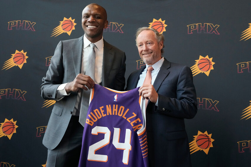 James Jones, left, then the Suns' president of basketball operations and general manager, holds up a uniform honoring the hire of new coach Mike Budenholzer, right, on May 17, 2024, in Phoenix. After a disappointing season where the Suns missed the postseason, Budenholzer has been fired and Jones has been demoted to a senior advisor role.
