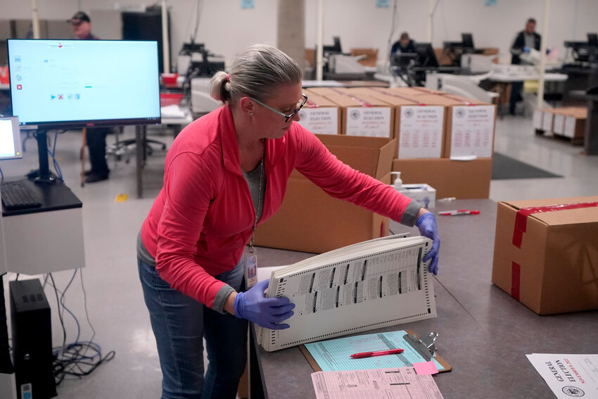 FILE - An election worker boxes tabulated ballots inside the Maricopa County Recorders Office, Nov. 9, 2022, in Phoenix. (AP Photo/Matt York, File)