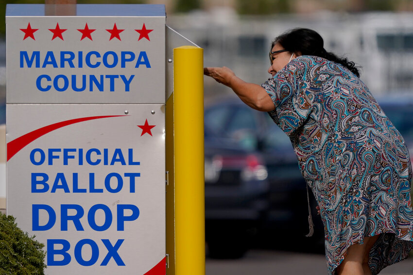 FILE - A voter drops off her ballot at a drop box, Nov. 7, 2022, in Mesa. Arizona Republicans in the Legislature want to change the way ballots can be collected and counted. (Associated Press/Matt York)