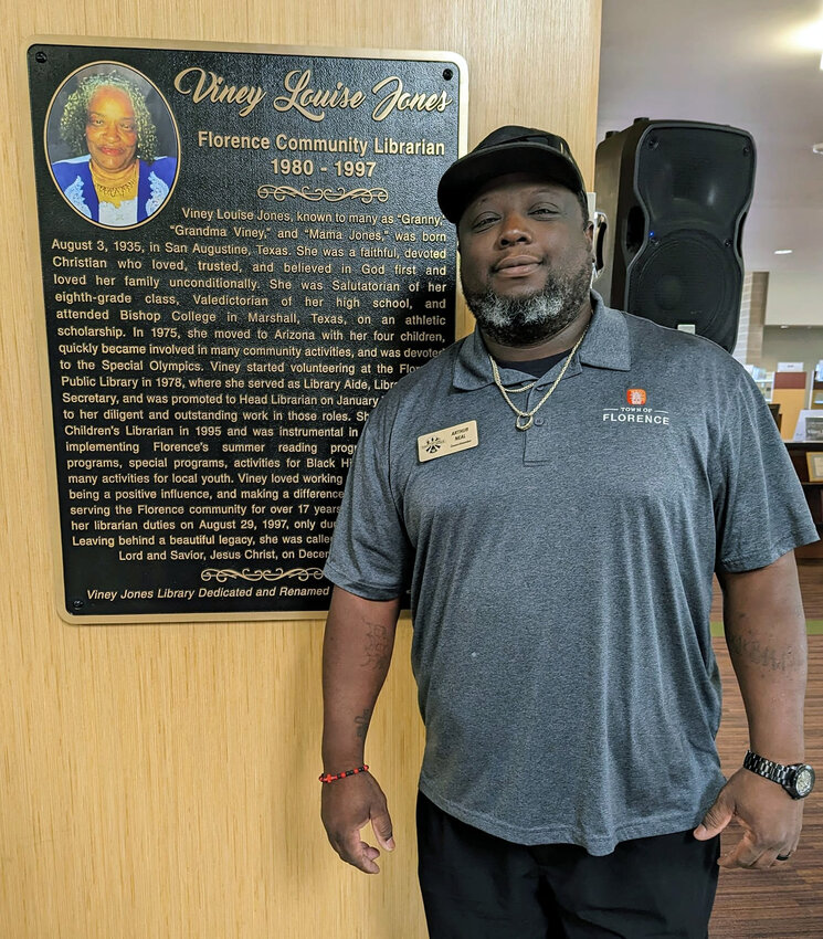 Florence Town Councilmember Arthur &ldquo;Snake&rdquo; Neal stands in front of the newly unveiled plaque for the Viney Jones Library and Community Center in November. Neal has just announced he will not be running for reelection this year.