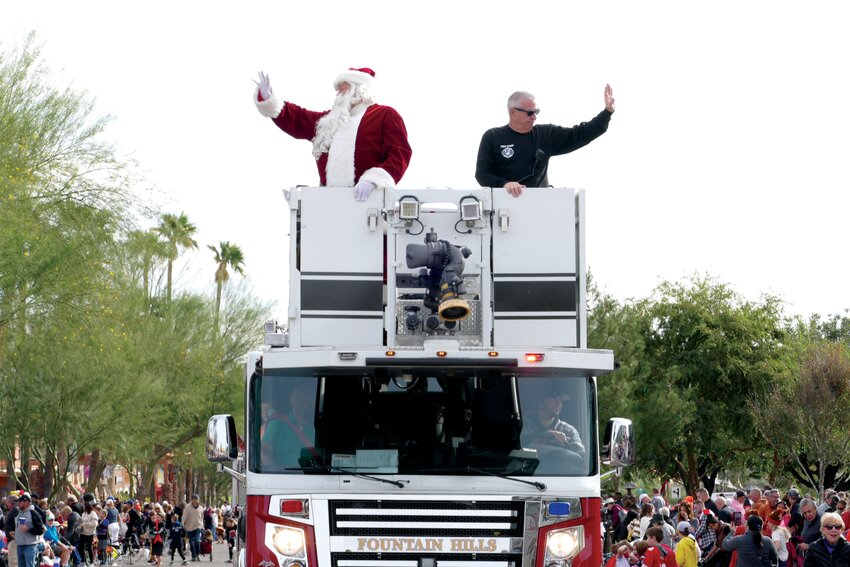 Santa Claus arrives to the Thanksgiving Day Parade in style, riding alongside Fire Chief Dave Ott. (Photos submitted by Bo Larsen with Town of Fountain Hills)