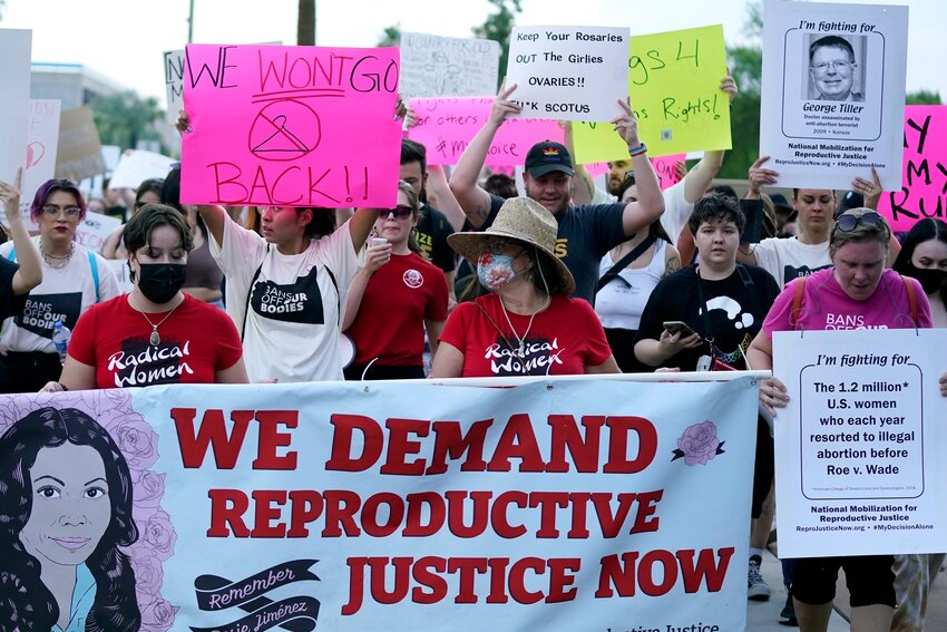 Thousands of protesters march around the Arizona Capitol June 24, 2022, in Phoenix. Arizona's territorial-era law outlawing abortion except to save the life of the mother is enforceable, the state Supreme Court ruled Tuesday. (Associated Press/Ross D. Franklin)