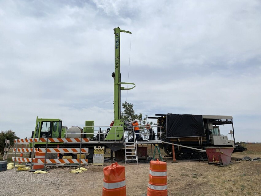 Air Force contractors use a truck-mounted sonic drilling rig and support truck to drill deep wells.  Luke AFB reps are moving forward with environmental remediation and will install monitoring wells to further determine human and ecological health risks, source areas, and migration patterns of Per-and polyfluoroalkyl substances (PFAS) contamination in groundwater around Goodyear.