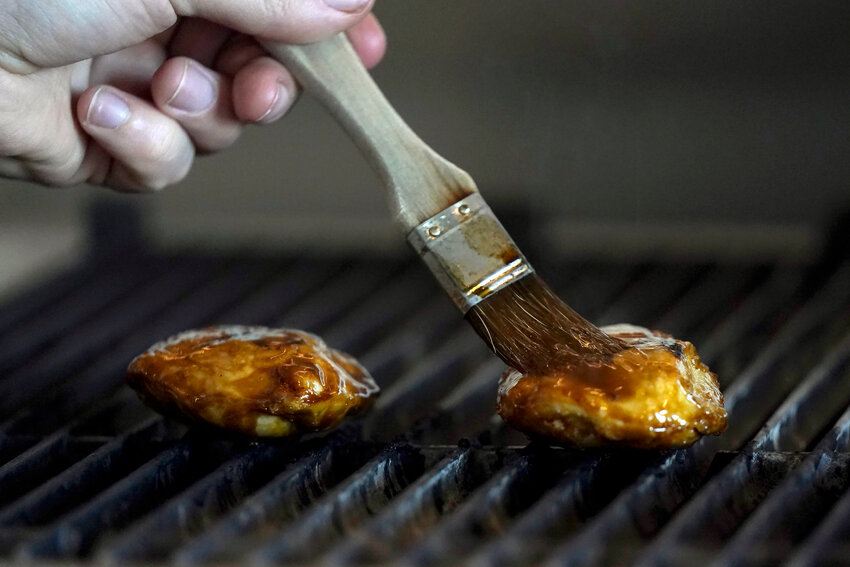 Chef Zach Tyndall prepares Good Meat&rsquo;s cultivated chicken at the Eat Just office in Alameda, Calif., Wednesday, June 14, 2023. The Arizona Senate this week clarified a bill one what labels must be on cultivated meat for sale to consumers. (Associated Press/Jeff Chiu)