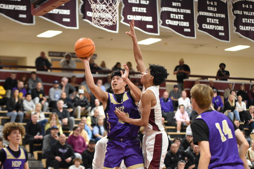 Notre Dame Prep junior Bryce Quinet beats Desert Mountain&rsquo;s sophomore Kaden House to the basket for a layup. (Independent Newsmedia/George Zeliff)
