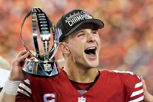 San Francisco 49ers quarterback Brock Purdy celebrates with the trophy after their win against the Detroit Lions in the NFC Championship NFL football game in Santa Clara, Calif., Sunday, Jan. 28, 2024.