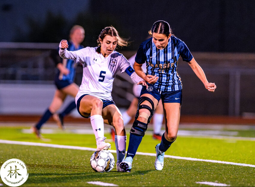 Caitlyn Kanter (5) of Glendale Prep tries to keep the ball away from a Benjamin Franklin player on Wednesday night.during a 3A girls soccer first round in Queen Creek.