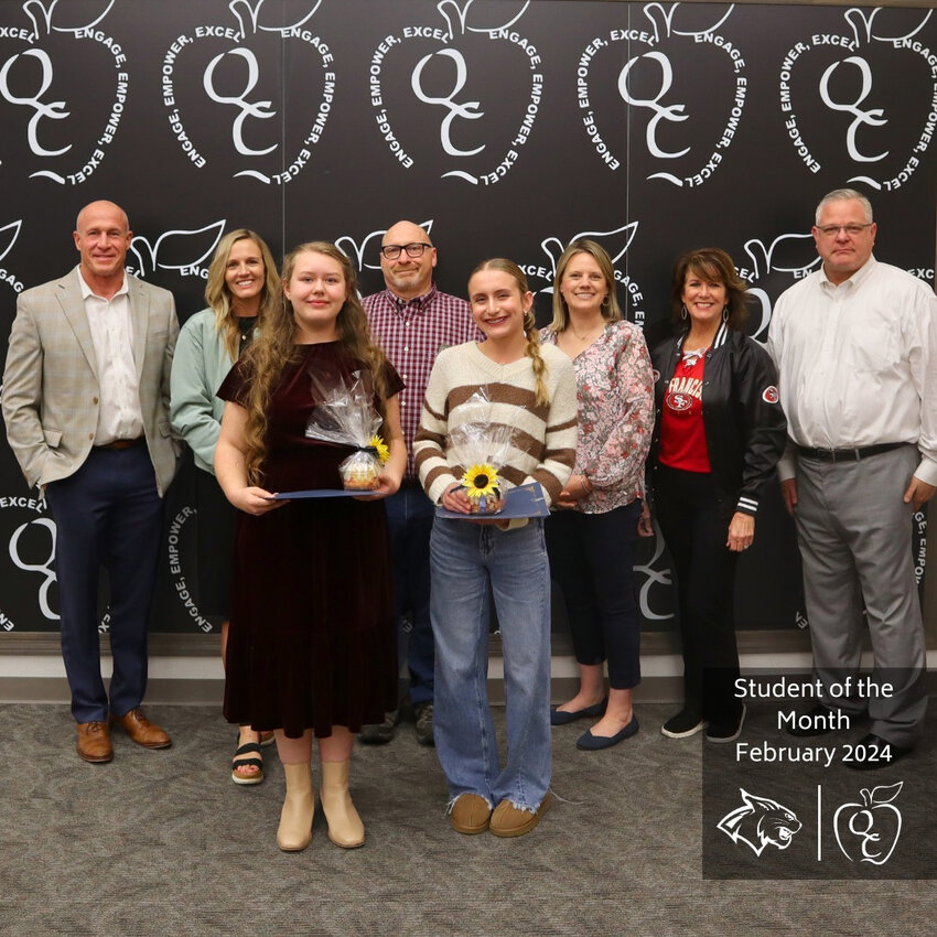 Ella Holyoak, front row left, and Ava Piracci, right, of Queen Creek Junior High were honored with the &quot;Student of the Month&quot; award for February during the Queen Creek Unified School District&rsquo;s Board of Governors meeting.