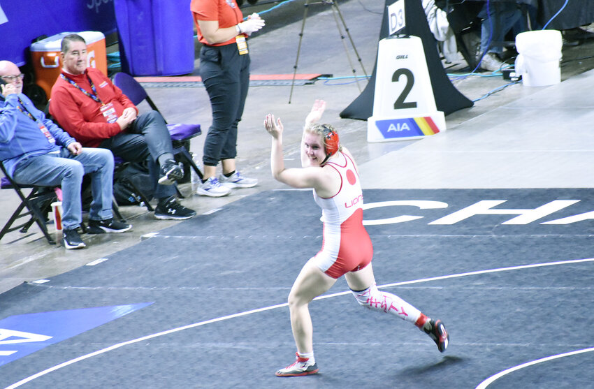 Claire Avery claps in celebration after pinning a Sunnyside opponent and winning the Division I girls 152-pound final Saturday during the state championships at Veterans Coliseum. Avery, one of three Lions to win individual state titles Saturday, helped Liberty win its third consecutive state team championship.