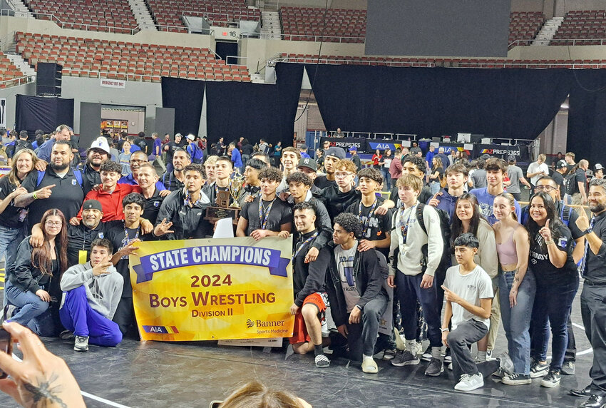 The Canyon View boys wrestling team poses with its Division II trophy Saturday at Veterans Coliseum after winning its first state team championship.