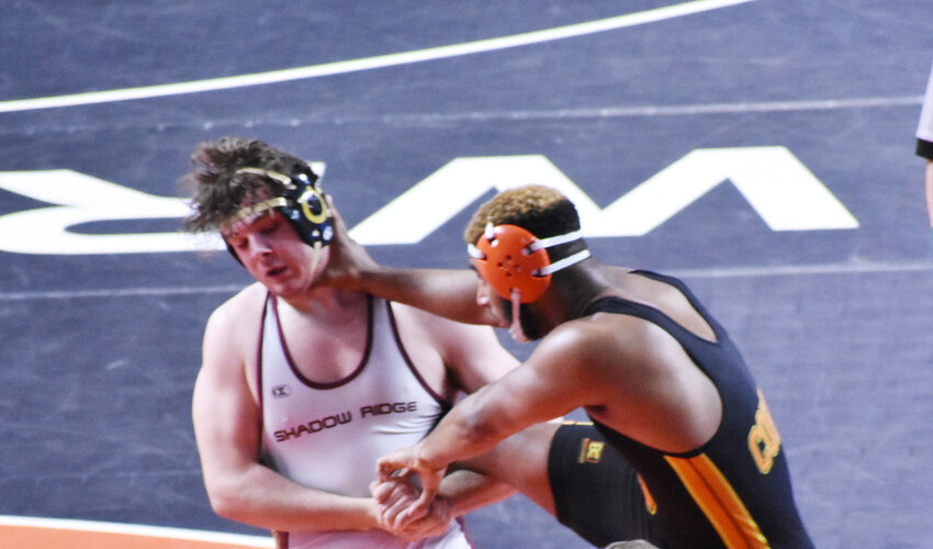Shadow Ridge senior Abel Garza, left, battles 215-pound Division I title opponent Aidan Odom of Corona del Sol on Feb. 17 in the state wrestling championships at Veterans Coliseum. Garza lost in overtime and placed second.