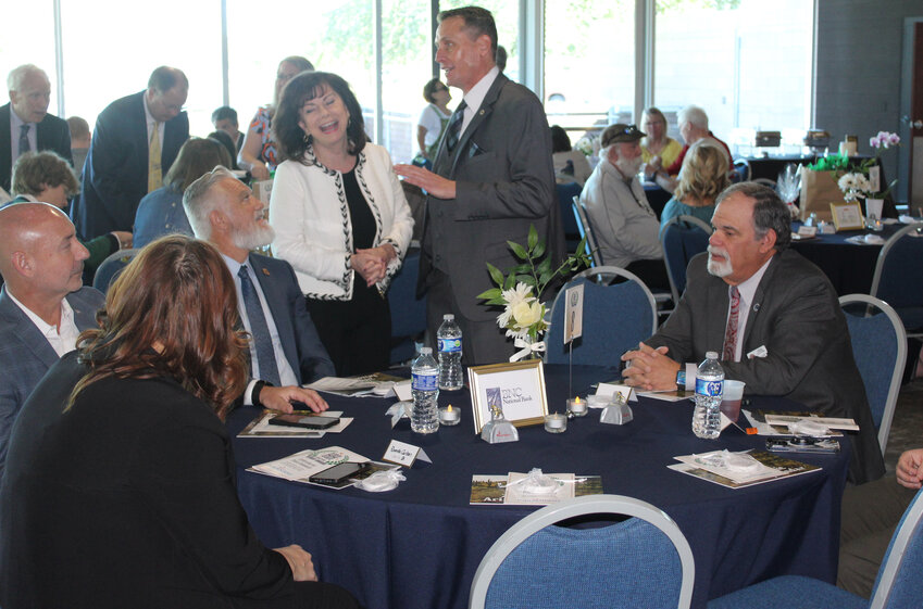 Former Peoria mayor Cathy Carlat and Hometown Hero in the Veteran category Tad Snidecor share a laugh at the Hometown Heroes luncheon, Feb. 20.