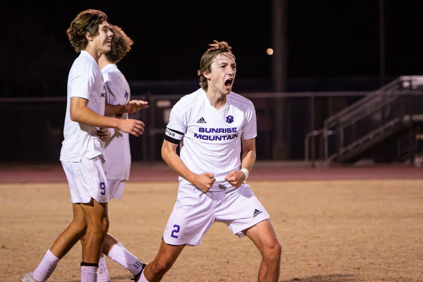 Sunrise Mountain senior forward Aiden Elam (#2) yells with delight, while junior Ryan Thompson smiles after the #10 seed Mustangs upset #3 Queen Creek Casteel 2-1 Tuesday nigh to reach the 5A state final Saturday against Ironwood.