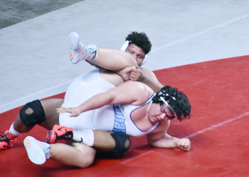 Arizona College Prep&rsquo;s Nick Hutchins, back, tries to control Deer Valley&rsquo;s Santiago Reyes on the mat during their 285-pound Division III state title match Feb. 17 at Veterans Coliseum. Hutchins won the championship match by a 2-1 score, helping the ACP boys place 10th in their division as a team.