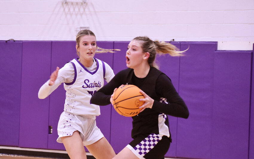 Millennium senior Elli Guiney looks to pass in the Feb. 24 5A quarterfinal as Notre Dame Prep&rsquo;s Olivia Frankel defends. The No. 7-seeded Tigers, powered by 29 points from Guiney, rolled past the host No. 2-seed Saints, 57-37, to advance to the 5A semifinals.