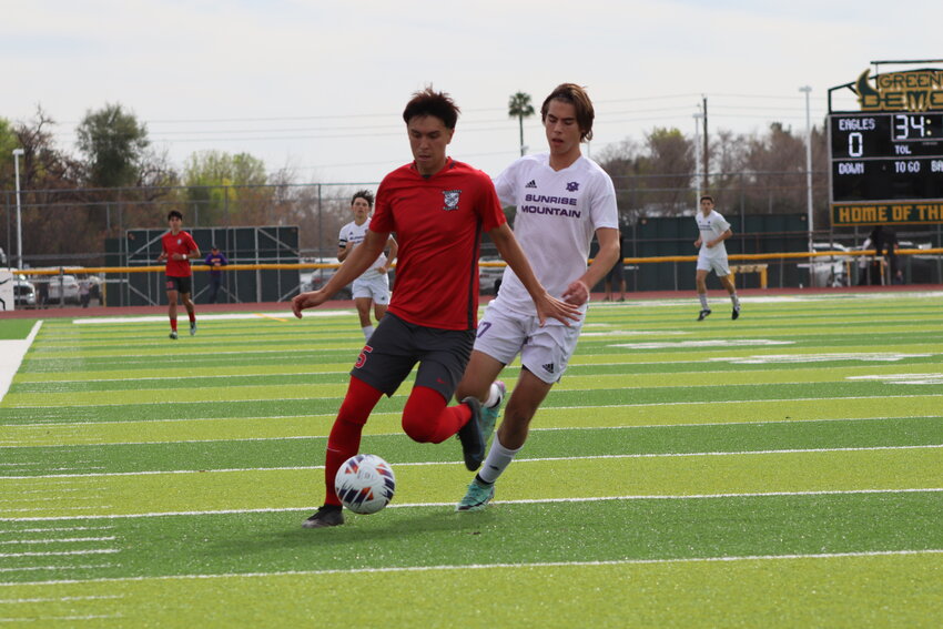 Ironwood sophomore Javier Valle dribbles upfield while Sunrise Mountain junior Connor Halley during the 5A state title game Feb. 24 at Greenway High School in Phoenix.