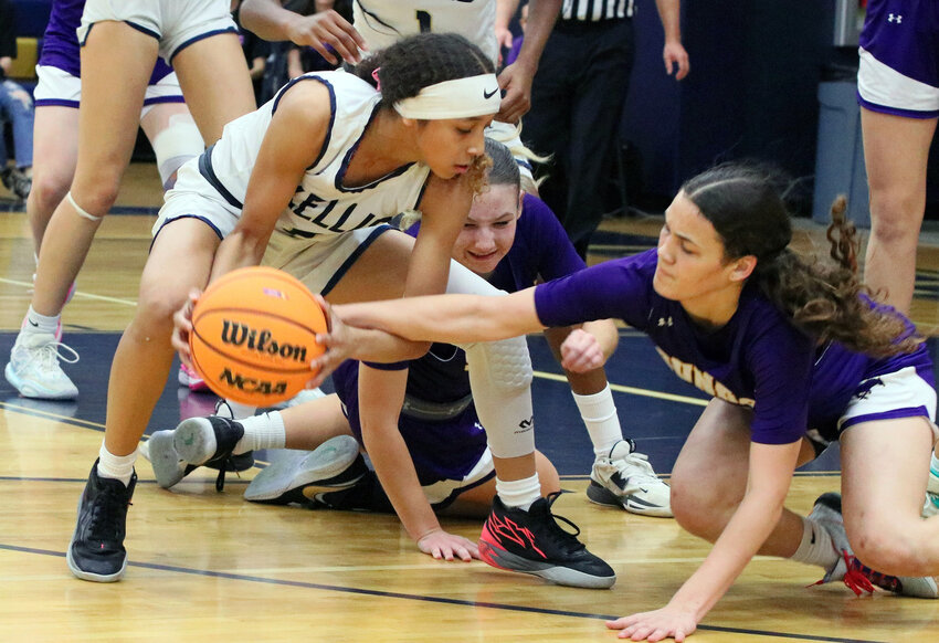 Sunrise Mountain junior guard Jaden Maza gets a hand on a loose ball as Kellis sophomore guars Shanielle Mallory grabs it during a 5A girls basketball quarterfinal at Kellis High School in Glendale.