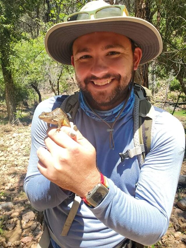 Brett Montgomery, a recent graduate of Arizona State University with a master&rsquo;s degree in applied biological sciences who specializes in amphibians, shows off a Chiricahua Leopard Frog, one of the state&rsquo;s indigenous frogs. (Provided by Brett Montgomery)