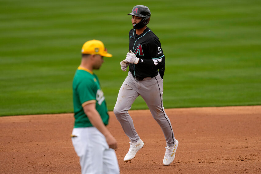 Diamondbacks' Jordan Lawlar rounds the bases after hitting a solo home run against the Oakland Athletics during the third inning of a spring training game, Monday at Hohokam Stadium in Mesa. (The Associated Press/Matt York)