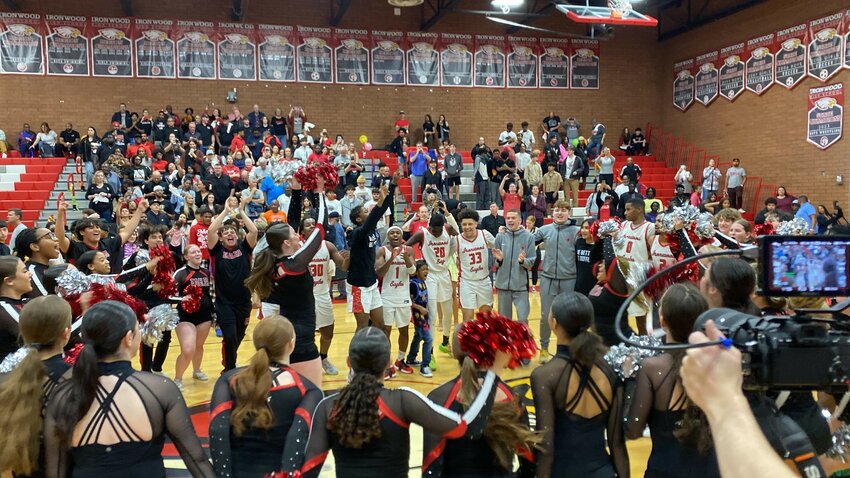 Ironwood boys basketball players, fans and cheerleaders celebrate the Eagles' 71-68 victory over Higley in a 5A boys basketball semifinal Feb. 28.